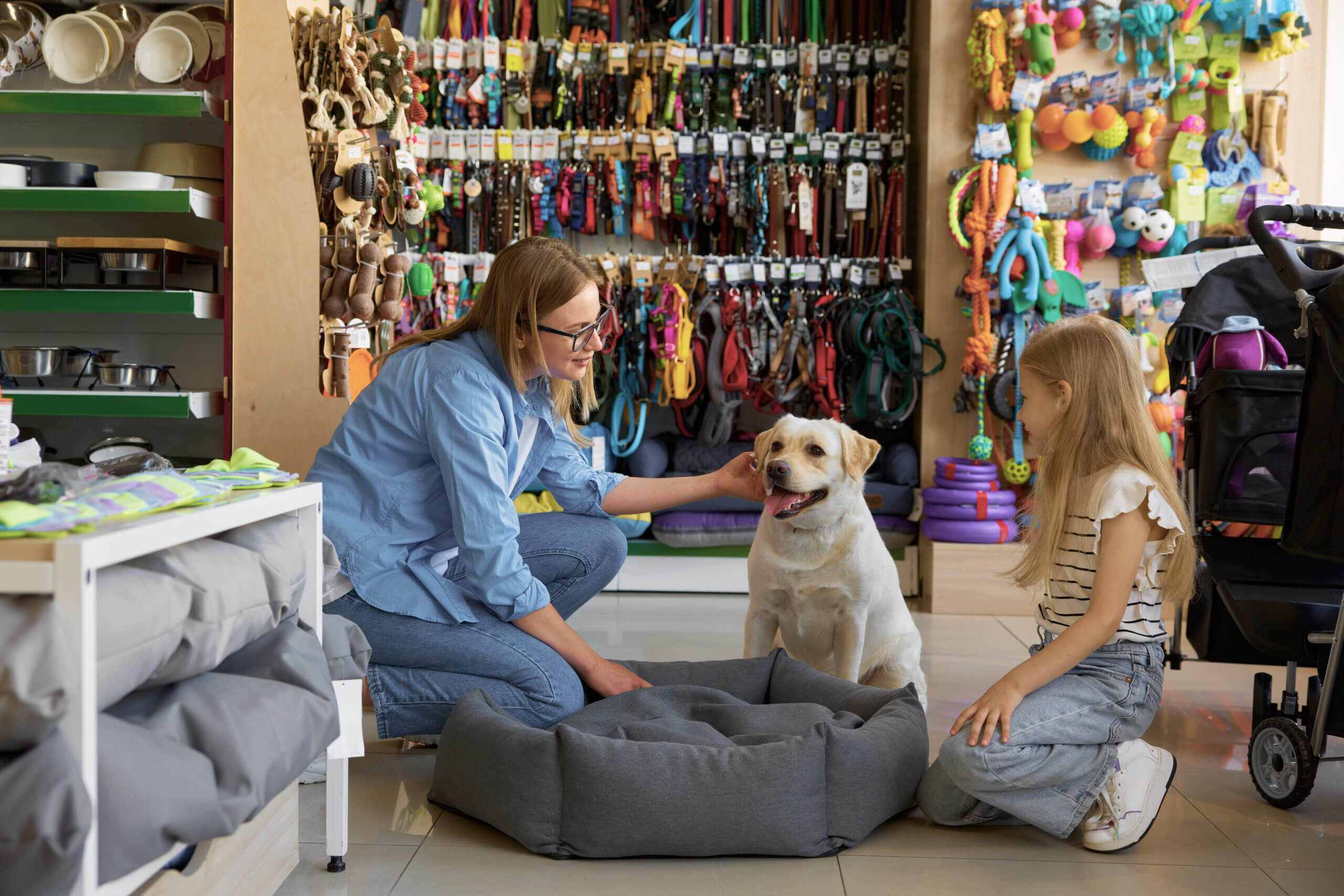 Mother and daughter choosing a bed for their dog in a pet store powered by a cloud-based POS system.