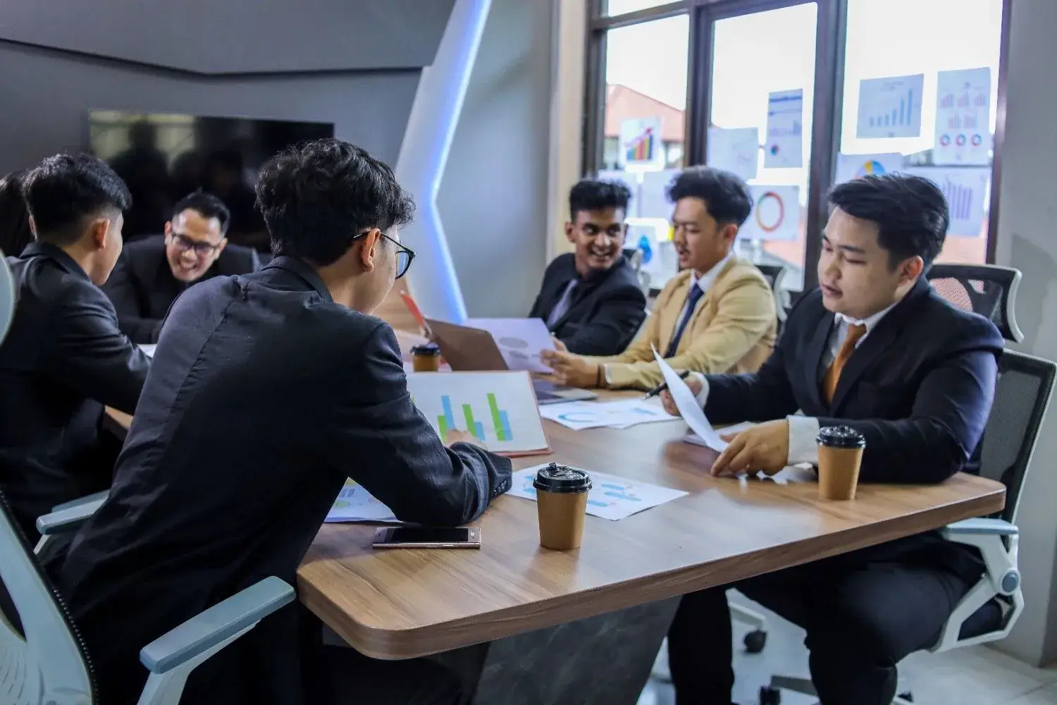 Group of young business people working together, representing MyTech Solutions’ Malaysia partnership with SalesPlay White-Label POS to boost sales and streamline merchant operations