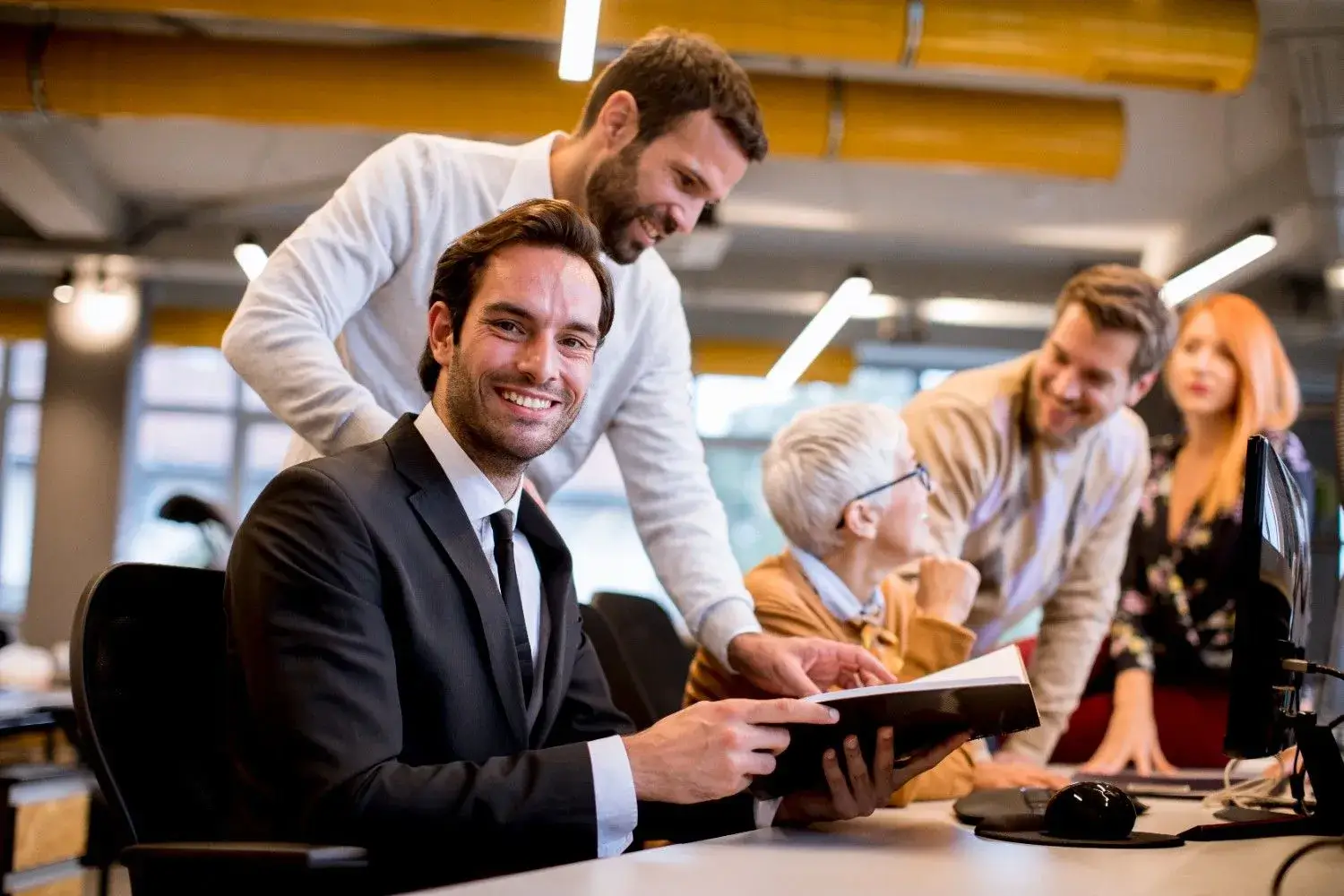 Senior businesswoman working together with young colleagues, representing PayPeak Solutions’ US partnership with SalesPlay White-Label POS to boost merchant growth and loyalty